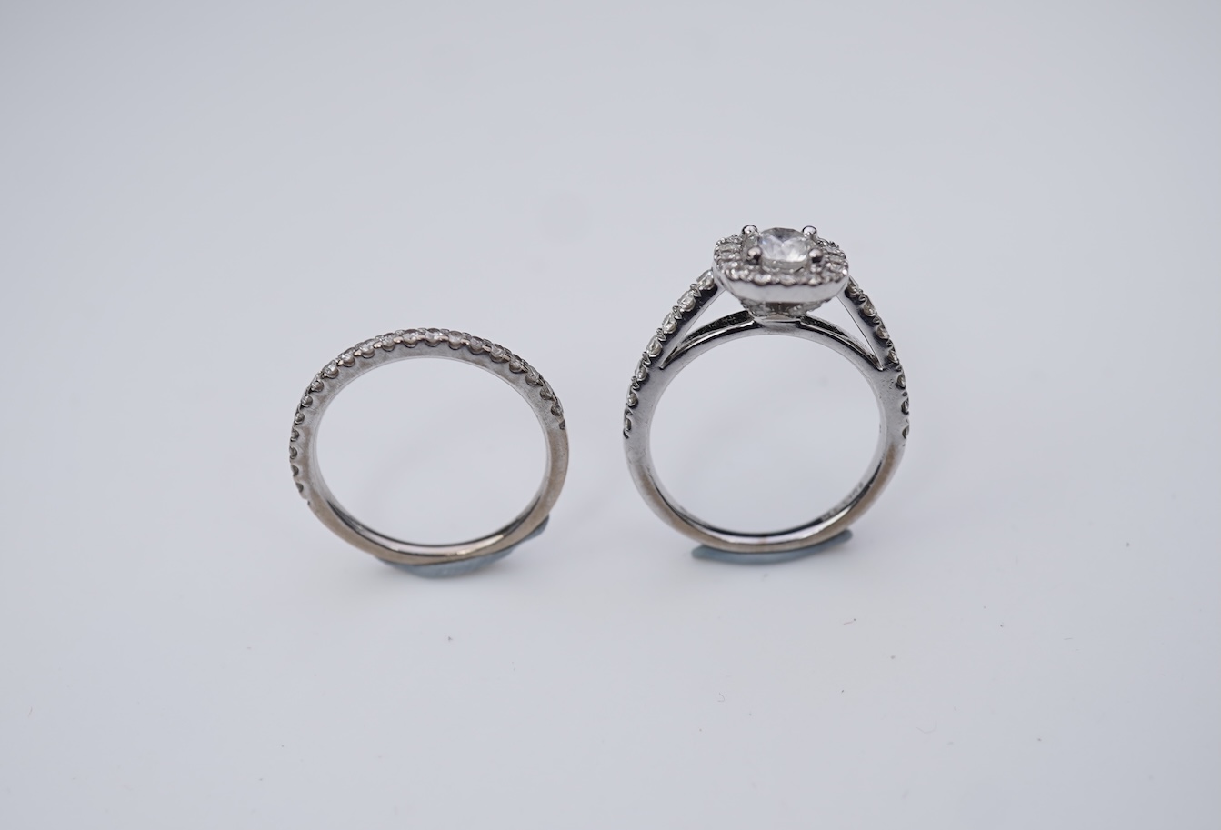 A diamond engagement ring and half eternity ring